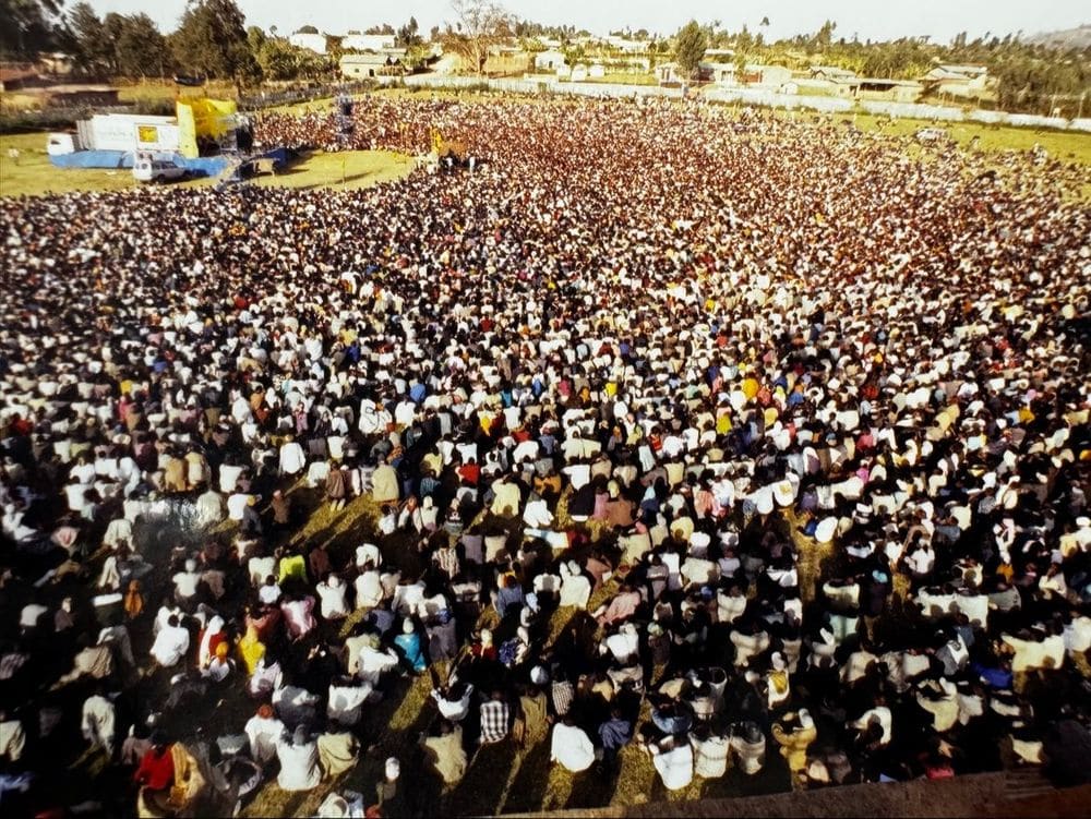 An older aerial photograph of a massive seated crusade crowd