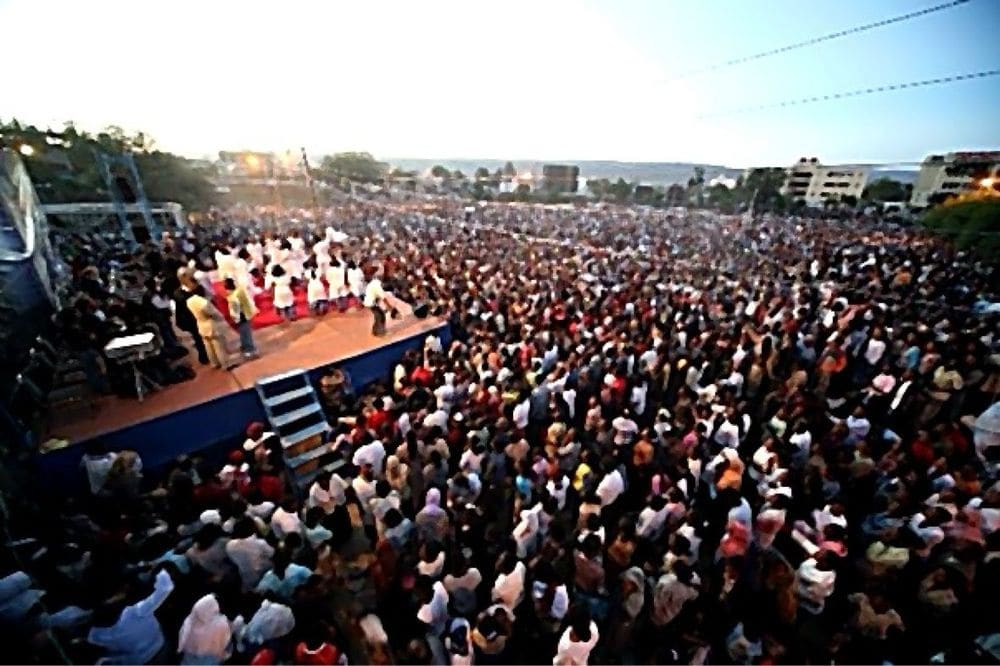 A historic night rally with a huge crowd and illuminated stage
