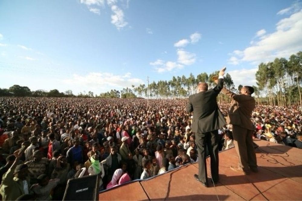 Karl Härgestam and another evangelist standing on stage before an enormous crowd