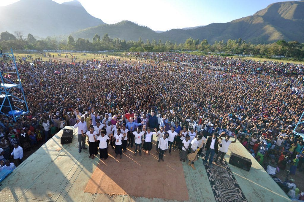 A Joshua Campaign crowd gathered before the stage in a mountain valley