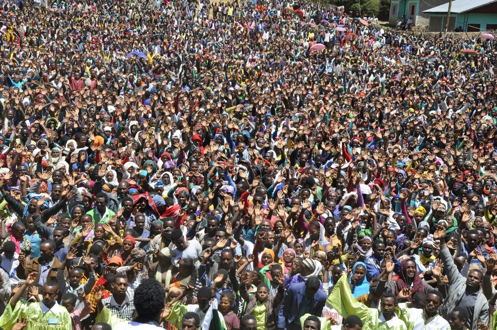 A vast Joshua Campaign crowd raising their hands