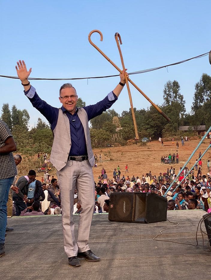 Per Åkvist holding crutches above the Joshua Campaign stage before a large crowd