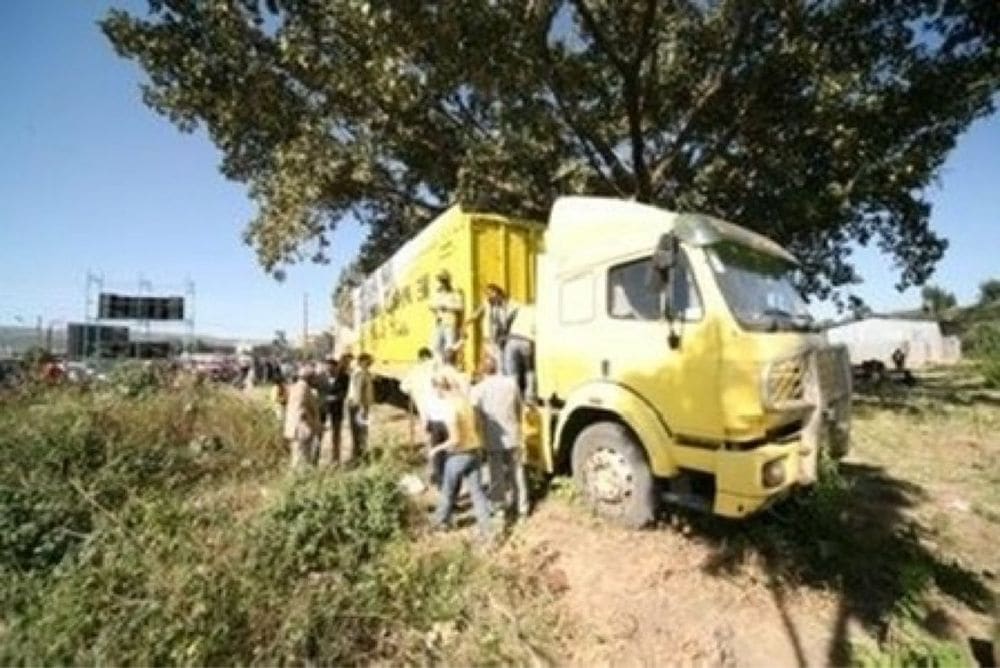 An early yellow Joshua Campaign sound-stage truck with the team gathered around it